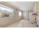 Bright laundry room features tile floors, a window, and access to the exterior with washer/dryer hookups at 3256 Roxborough Ave, Clearwater, FL 33762
