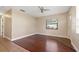 Cozy living room with stylish hardwood floors, natural light, and easy transition to dining area at 3256 Roxborough Ave, Clearwater, FL 33762