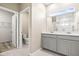 Bathroom boasts double vanity, ample counter space, and tiled floors; a blend of style and functionality at 34024 White Fountain Ct, Wesley Chapel, FL 33545