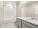 Bathroom featuring white tile, updated vanity, modern sink, and tub with shower at 34024 White Fountain Ct, Wesley Chapel, FL 33545