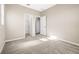 Neutral bedroom featuring carpet floors, walk-in closet, and light-filled walls at 34024 White Fountain Ct, Wesley Chapel, FL 33545