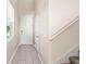 Hallway featuring neutral walls, tile flooring, and staircase at 34024 White Fountain Ct, Wesley Chapel, FL 33545