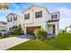 Attractive home showcasing a paver driveway, well-maintained lawn, and warm, inviting colors at 34024 White Fountain Ct, Wesley Chapel, FL 33545