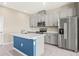 Bright kitchen features stainless appliances, an island, and grey cabinets providing a modern, fresh look at 34024 White Fountain Ct, Wesley Chapel, FL 33545