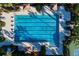 Aerial shot of the neighborhood pool featuring lap lanes, poolside chairs, and green landscaping at 34024 White Fountain Ct, Wesley Chapel, FL 33545