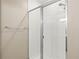 Bathroom shower features glass doors, a dual shower head, and white tile, offering a luxurious experience at 34024 White Fountain Ct, Wesley Chapel, FL 33545