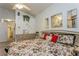Comfortable bedroom with floral comforter, decorative mirrors, and a ceiling fan for a relaxing space at 3627 Cypress Meadows Rd, Tampa, FL 33624