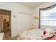 Inviting bedroom with a floral-themed bedspread, large window for natural light, and ample closet space at 3627 Cypress Meadows Rd, Tampa, FL 33624