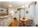 Charming dining area features a chandelier and a breakfast bar, perfect for everyday meals and entertaining guests at 3627 Cypress Meadows Rd, Tampa, FL 33624