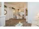 Dining room with glass table and chairs, featuring arched doorway and mirrored wall at 3627 Cypress Meadows Rd, Tampa, FL 33624