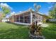 A view of the exterior lanai and backyard, highlighting the home's outdoor living space at 3627 Cypress Meadows Rd, Tampa, FL 33624