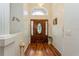 Elegant foyer featuring a decorative front door, chandelier, and pristine flooring at 3627 Cypress Meadows Rd, Tampa, FL 33624