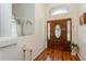 Bright foyer with a stained glass front door, elegant flooring, and classic decor at 3627 Cypress Meadows Rd, Tampa, FL 33624