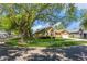 Landscaped home exterior with mature trees and well-maintained lawn on a sunny day at 3627 Cypress Meadows Rd, Tampa, FL 33624