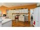 Well-lit kitchen with orange accent wall, white cabinets, stainless steel oven, and eat-in breakfast bar at 3627 Cypress Meadows Rd, Tampa, FL 33624