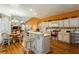Open kitchen with white cabinets, stainless steel appliances, a breakfast bar, and adjoining living spaces at 3627 Cypress Meadows Rd, Tampa, FL 33624