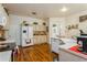 Bright kitchen featuring wood floors, white cabinets, a stainless steel oven, and plenty of counter space at 3627 Cypress Meadows Rd, Tampa, FL 33624