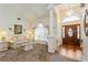 Open living room showcasing a front door view, a large window, and neutral tones at 3627 Cypress Meadows Rd, Tampa, FL 33624