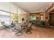 Inviting screened patio with tile flooring, outdoor seating, and bar, perfect for entertaining at 3627 Cypress Meadows Rd, Tampa, FL 33624