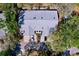 Aerial view of attached villas shows the parking areas and surrounding trees at 39650 Us Highway 19 N # 411, Tarpon Springs, FL 34689