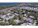 Community aerial view showing the neighborhood layout with mature trees and nearby highway at 39650 Us Highway 19 N # 411, Tarpon Springs, FL 34689