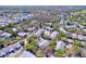 Aerial view of the neighborhood showcasing lush greenery, ponds and residential homes at 39650 Us Highway 19 N # 411, Tarpon Springs, FL 34689
