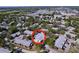 An aerial view shows the home surrounded by mature trees in a well-maintained community at 39650 Us Highway 19 N # 411, Tarpon Springs, FL 34689