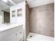 Updated bathroom features a tiled shower, new vanity with storage, and decorative ceiling tiles at 39650 Us Highway 19 N # 411, Tarpon Springs, FL 34689