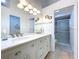 Elegant bathroom featuring a double sink vanity, modern fixtures, framed mirrors, and a glass-enclosed shower at 39650 Us Highway 19 N # 411, Tarpon Springs, FL 34689