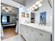 Bathroom features a double sink vanity, a large mirror, and access to an en-suite bedroom at 39650 Us Highway 19 N # 411, Tarpon Springs, FL 34689