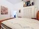 Bright bedroom features a vaulted ceiling, closet with bi-fold doors, and decorative display shelf at 39650 Us Highway 19 N # 411, Tarpon Springs, FL 34689