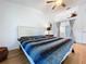 Spacious bedroom with a ceiling fan and a view of the ensuite bathroom at 39650 Us Highway 19 N # 411, Tarpon Springs, FL 34689