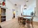 Dining area with wood flooring with views to the kitchen and decorative barn door at 39650 Us Highway 19 N # 411, Tarpon Springs, FL 34689