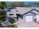 Inviting gray home with attached garage, mature trees, and landscaping at 39650 Us Highway 19 N # 411, Tarpon Springs, FL 34689