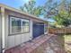 View of sunroom attached to the house, as well as the fenced in yard at 39650 Us Highway 19 N # 411, Tarpon Springs, FL 34689