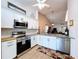 Bright kitchen featuring stainless steel appliances, white cabinetry, granite countertops, and an open-concept design at 39650 Us Highway 19 N # 411, Tarpon Springs, FL 34689