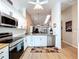 Inviting kitchen with modern appliances, white cabinets, granite counters, and a clear view into the adjoining living space at 39650 Us Highway 19 N # 411, Tarpon Springs, FL 34689