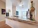 A partial view of kitchen with granite countertops, view from dining area at 39650 Us Highway 19 N # 411, Tarpon Springs, FL 34689