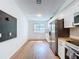 Bright kitchen boasts white cabinets, stainless steel appliances, butcher block countertops, and durable wood-look flooring at 39650 Us Highway 19 N # 411, Tarpon Springs, FL 34689