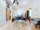 Living room with high ceilings, wood flooring, decorative piano bar and barn door at 39650 Us Highway 19 N # 411, Tarpon Springs, FL 34689