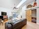 Living room with high ceilings, wood flooring and a decorative sliding barn door at 39650 Us Highway 19 N # 411, Tarpon Springs, FL 34689