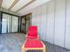 Relaxing screened-in patio with lounge chair and outdoor rug at 39650 Us Highway 19 N # 411, Tarpon Springs, FL 34689