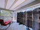 Screened-in patio with red lounge chair and privacy screens at 39650 Us Highway 19 N # 411, Tarpon Springs, FL 34689