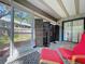 Cozy sunroom features a tile floor, decorative screens, and comfortable furniture at 39650 Us Highway 19 N # 411, Tarpon Springs, FL 34689