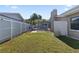 Spacious backyard featuring a pool with screened enclosure, well-kept lawn and partial fencing at 4219 Summerdale Dr, Tampa, FL 33624