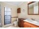 Bathroom with a tiled floor, wood cabinets and a toilet and walk-in shower at 4219 Summerdale Dr, Tampa, FL 33624