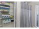Bathroom linen closet featuring wire shelves and stocked with folded towels near a shower at 4219 Summerdale Dr, Tampa, FL 33624