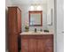 Bathroom featuring a vanity, storage cabinet, and modern lighting at 4219 Summerdale Dr, Tampa, FL 33624