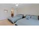 Bright bedroom featuring blue bedspreads with view into bathroom at 4219 Summerdale Dr, Tampa, FL 33624