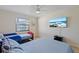 Bright bedroom with two twin beds, window, ceiling fan, and mounted TV at 4219 Summerdale Dr, Tampa, FL 33624